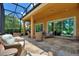 Inviting screened patio featuring comfortable wicker seating and serene views of the lush backyard at 346 Treviso Dr, Kissimmee, FL 34759