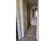Hallway view of bathroom with a neutral vanity and toilet at 3502 Windy Walk Way # 2-208, Orlando, FL 32837