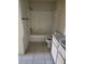Bathroom featuring white tiled shower, matching toilet and vanity at 3502 Windy Walk Way # 2-208, Orlando, FL 32837