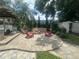 Expansive backyard with fire pit, Adirondack chairs, and outdoor living area at 3715 Sarasota Ct, Orlando, FL 32812