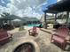 Sprawling backyard with a pool, outdoor kitchen, fire pit, and multiple lounge areas at 3715 Sarasota Ct, Orlando, FL 32812