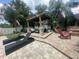 Beautiful backyard featuring a pergola, lounge chairs, fire pit, and ample seating at 3715 Sarasota Ct, Orlando, FL 32812