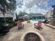 Spacious backyard featuring an outdoor kitchen, pool, fire pit, and comfortable lounge seating at 3715 Sarasota Ct, Orlando, FL 32812