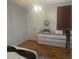 Bedroom with a dresser, decorative mirror, and wood-look floors at 3715 Sarasota Ct, Orlando, FL 32812
