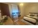 Inviting bedroom with modern desk setup, wood-look floors, and a comfortable bed at 3715 Sarasota Ct, Orlando, FL 32812