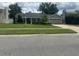 Well-maintained single-story home with a green lawn and an attached two-car garage at 3715 Sarasota Ct, Orlando, FL 32812