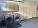 Functional laundry area in garage featuring washer, dryer, storage cabinets and utility sink at 3715 Sarasota Ct, Orlando, FL 32812