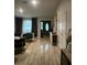 Open-concept living room featuring a tiled floor, modern furniture, and a front door with glass inserts at 3715 Sarasota Ct, Orlando, FL 32812