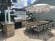 Outdoor kitchen and dining area with grill, granite counters and seating for ten at 3715 Sarasota Ct, Orlando, FL 32812