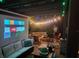 Inviting outdoor patio with a firepit, comfortable seating, string lights, and a projector for movie nights at 3715 Sarasota Ct, Orlando, FL 32812