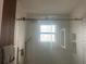 Sleek shower featuring a glass enclosure, tiled walls with recessed niche, and modern fixtures at 3715 Sarasota Ct, Orlando, FL 32812