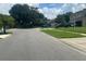 A daytime street view of a residential neighborhood showcases well-maintained lawns and various parked trucks at 3715 Sarasota Ct, Orlando, FL 32812