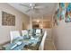 Chic dining room with a glass table, white chairs, and modern decor at 4160 Pershing Pointe Pl # 1, Orlando, FL 32822