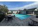 Community pool with various seating options and pool house at 4160 Pershing Pointe Pl # 1, Orlando, FL 32822