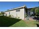 A portion of the home's exterior featuring a screened in patio, landscaping and lush green grass at 455 Cinnamon Dr, Kissimmee, FL 34759