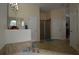 Bright bathroom featuring tile flooring, a glass-enclosed shower, and a soaking tub at 455 Cinnamon Dr, Kissimmee, FL 34759