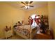 Bedroom with a floral comforter on the bed, red and white striped curtains, and white furniture at 455 Cinnamon Dr, Kissimmee, FL 34759