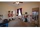 Bedroom with carpet, ceiling fan and window with red curtains at 455 Cinnamon Dr, Kissimmee, FL 34759