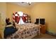 Bedroom with a floral comforter on the bed, red and white striped curtains, and white furniture at 455 Cinnamon Dr, Kissimmee, FL 34759