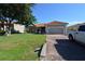 Charming single-story home featuring a red tile roof, brick driveway, and well-maintained landscaping at 455 Cinnamon Dr, Kissimmee, FL 34759