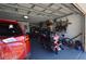 Spacious garage featuring parking for a car and motorcycle with ample storage space at 455 Cinnamon Dr, Kissimmee, FL 34759