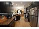Modern kitchen featuring granite countertops, stainless steel appliances, and dark cabinetry at 455 Cinnamon Dr, Kissimmee, FL 34759