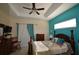 Bright main bedroom with tray ceiling, white and turquoise accents and natural light at 455 Cinnamon Dr, Kissimmee, FL 34759
