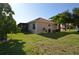 A portion of the home's exterior featuring lush landscaping at 455 Cinnamon Dr, Kissimmee, FL 34759