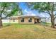 View of home backyard featuring trees, patio area, and fenced yard for privacy at 4828 Jeanette Ct, St Cloud, FL 34771