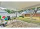 Outdoor patio area with brick pavers, comfortable seating, white fence, and partial shade at 4828 Jeanette Ct, St Cloud, FL 34771