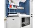 Well-lit laundry room featuring side-by-side washer and dryer, shelving and storage at 4828 Jeanette Ct, St Cloud, FL 34771