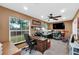 A home office featuring a large desk, shelving, and natural light from a big window at 4828 Jeanette Ct, St Cloud, FL 34771