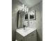 Modern bathroom vanity with white counter-top, framed mirror and stylish vanity light at 5967 Village Cir # Ge, Orlando, FL 32822