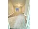An empty bedroom with a grey carpet, ceiling fan, and a single window that brings in natural light at 5967 Village Cir # Ge, Orlando, FL 32822