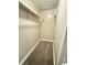 Walk-in closet featuring carpet flooring and shelving for optimal storage solutions at 5967 Village Cir # Ge, Orlando, FL 32822