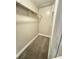 Walk-in closet featuring carpet flooring and shelving for optimal storage solutions at 5967 Village Cir # Ge, Orlando, FL 32822