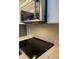 Close-up of a modern kitchen featuring a stainless steel microwave, stove, light countertops, and gray backsplash at 5967 Village Cir # Ge, Orlando, FL 32822