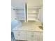Open white kitchen cabinets with quartz countertops and stainless steel hardware at 5967 Village Cir # Ge, Orlando, FL 32822