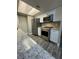 Modern kitchen features stainless steel appliances, white cabinets, granite counters, and wood flooring at 5967 Village Cir # Ge, Orlando, FL 32822