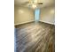 Spacious living room features wood floors, neutral walls, ceiling fan, and lots of natural light at 5967 Village Cir # Ge, Orlando, FL 32822