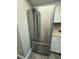 Modern kitchen with stainless steel refrigerator and white cabinets at 5967 Village Cir # Ge, Orlando, FL 32822