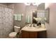Bathroom featuring a patterned shower curtain, wooden cabinets, sink with vanity, and neutral walls at 6100 Stevenson Dr # 202, Orlando, FL 32835