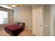 Bedroom with neutral walls, carpeted floors, a large window and a door that provides access to another room at 6100 Stevenson Dr # 202, Orlando, FL 32835