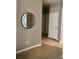 Entryway with tile floors, a stylish mirror on the wall, and a white door leading to another room at 6100 Stevenson Dr # 202, Orlando, FL 32835