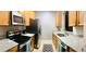 Galley-style kitchen featuring stainless steel appliances, granite countertops and plenty of wooden cabinets at 6100 Stevenson Dr # 202, Orlando, FL 32835