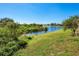 Picturesque backyard view showcasing the tranquil pond and lush greenery, offering a serene outdoor setting at 7912 Golden Pond Cir, Kissimmee, FL 34747