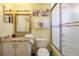 Cozy bathroom featuring vanity with granite top, shower, and New York themed wall decor at 7912 Golden Pond Cir, Kissimmee, FL 34747