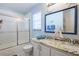 Bathroom featuring double sinks, granite countertop, walk-in shower at 7912 Golden Pond Cir, Kissimmee, FL 34747