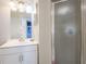 Bathroom with white vanity, shower and frosted glass door at 7912 Golden Pond Cir, Kissimmee, FL 34747