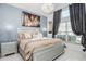 Bedroom with a king bed, chandelier, and large window at 7912 Golden Pond Cir, Kissimmee, FL 34747